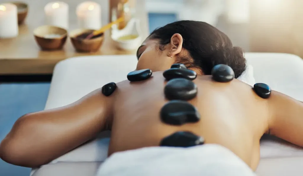 Image of a woman showing Hot Stone Massage by Holistic Massage & Spa