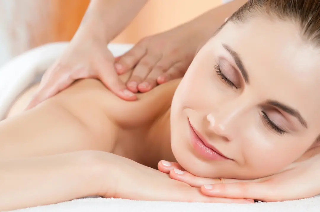 Image of a smiling woman getting massage therapy